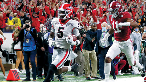 Georgia Bulldogs defensive back Kelee Ringo (5) returns a interception for a touchdown during the College Football Playoff National Championship at Lucas Oil Stadium in Indiana.